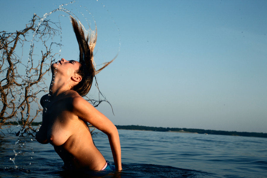 beach breasts hair_flip hanging_breasts in_water krista leaning_forward outside splash topless wet