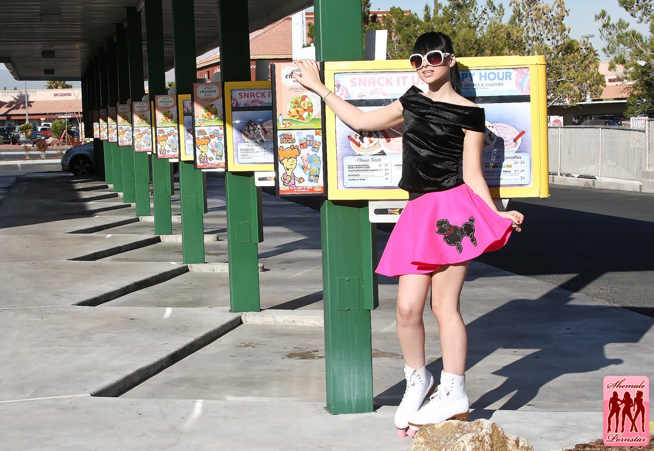 bailey_jay black_hair breasts large_breasts long_hair roller_skates shemale solo watermark
