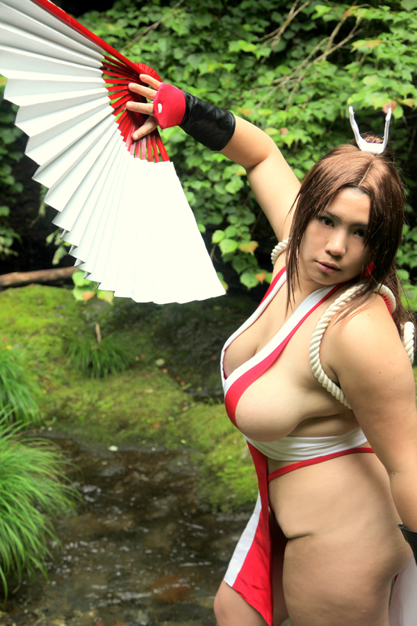breasts brown_eyes brown_hair chouzuki_maryou cosplay fan female female_only hair_ornament king_of_fighters large_breasts long_hair mai_shiranui mai_shiranui_(cosplay) plump ponytail pose sideboob snk solo thick_thighs thighs tied_hair very_long_hair