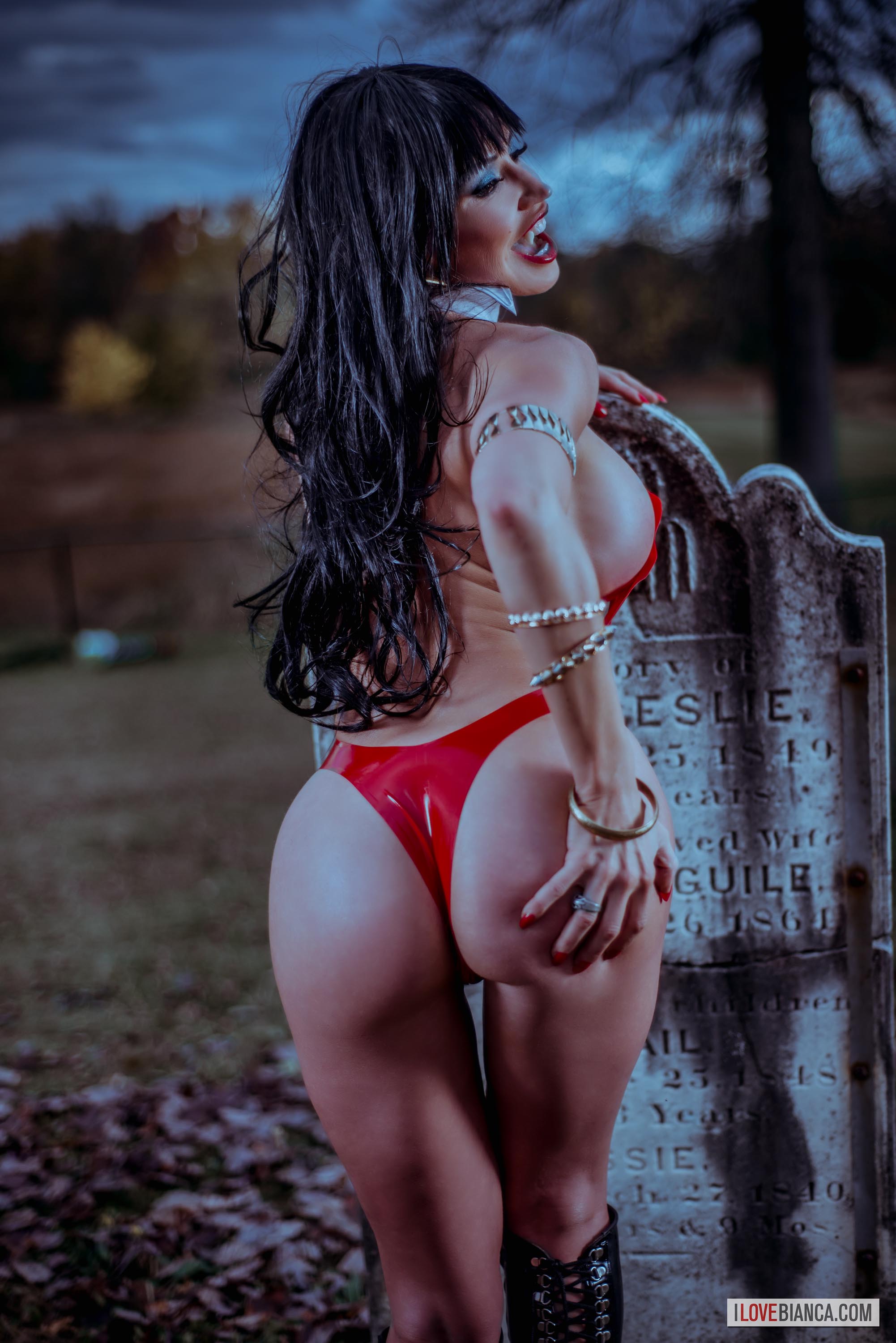 1girl ass ass_grab bare_shoulders bianca_beauchamp breasts cosplay dark_hair female female_only high_heels knee_boots large_breasts latex long_hair looking_back open_mouth outside partially_clothed sideboob solo thong vampirella watermark