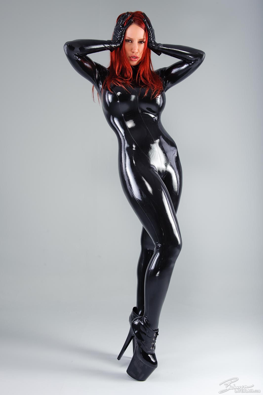 bianca_beauchamp breasts catsuit female gloves high_heels large_breasts latex long_hair red_hair shoes simple_background solo watermark