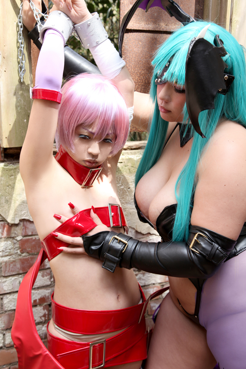 2girls aqua_hair armpits arms_up bare_shoulders breasts capcom chouzuki_maryou cleavage collar cosplay darkstalkers fake_nails female female_only hand_on_breast huge_breasts lilith_aensland long_hair morrigan_aensland non-nude partially_clothed plump purple_hair solo succubus suzuka_itsuki watermark wings