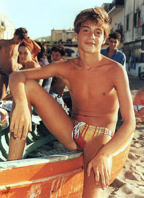 beach boat boy brown_hair male outside photo public smile speedo teen