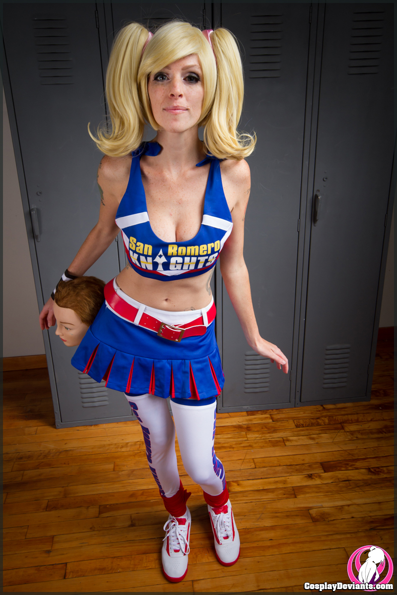 blonde_hair breasts chainsaw cosplay cosplaydeviants female juliet_starling kneehighs large_breasts lolita_zombie lollipop_chainsaw long_hair pigtails shoes solo watermark weapon