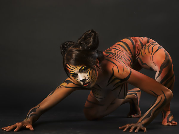 1girl animal animal_paint bodypaint breasts female female_only photo real_person solo tiger_stripes