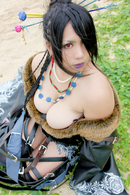 asian beach belt big_breasts black_hair braid breasts bun chouzuki_maryou cleavage cosplay dress final_fantasy final_fantasy_x fur hair_bun hair_over_one_eye hairpin japanese kneehighs looking_at_viewer lulu_(final_fantasy) nail_polish necklace pearl_necklace photo real real_person red_eyes sand sitting
