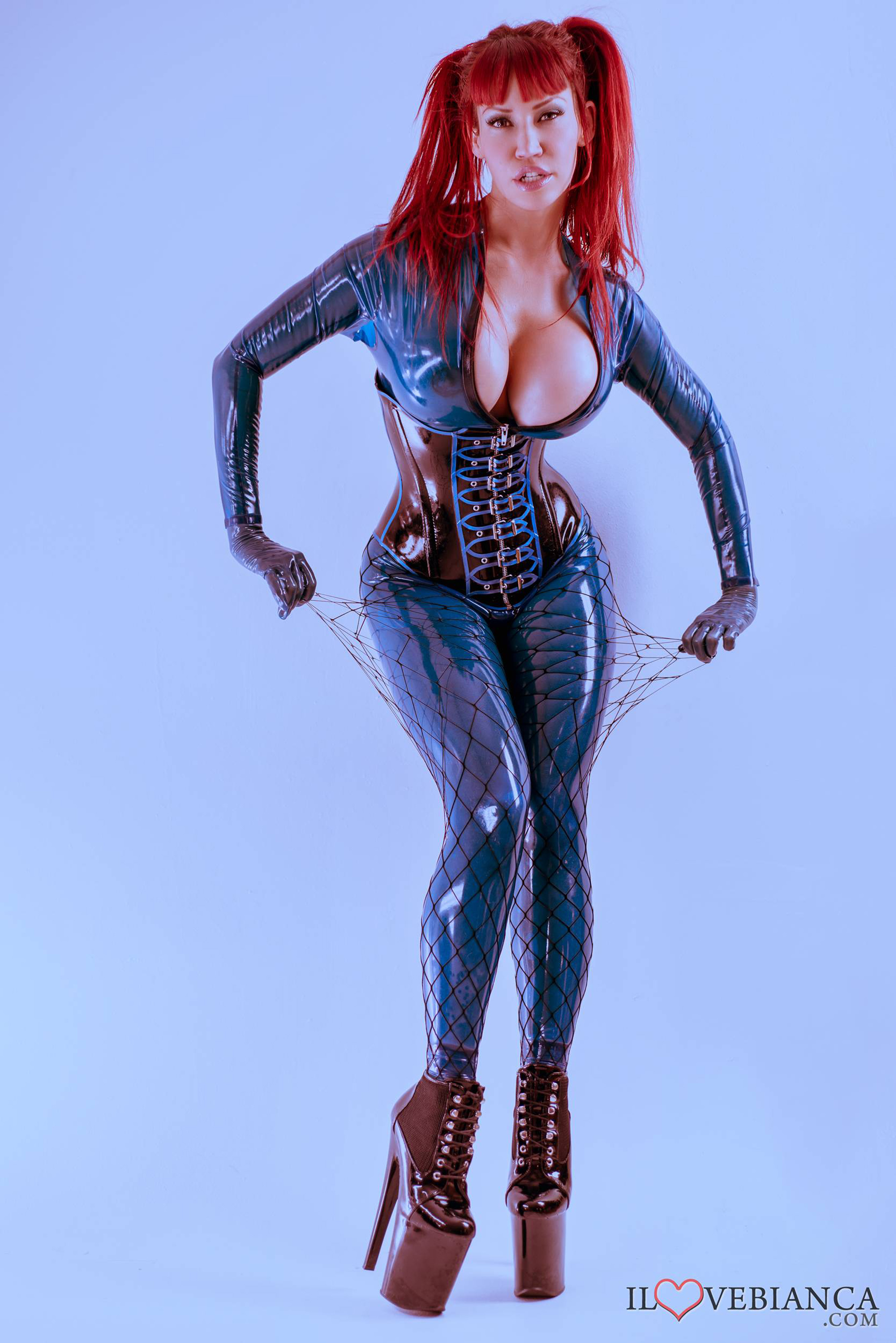 bianca_beauchamp boots breasts catsuit corset female gloves high_heels large_breasts latex long_hair red_hair simple_background solo watermark