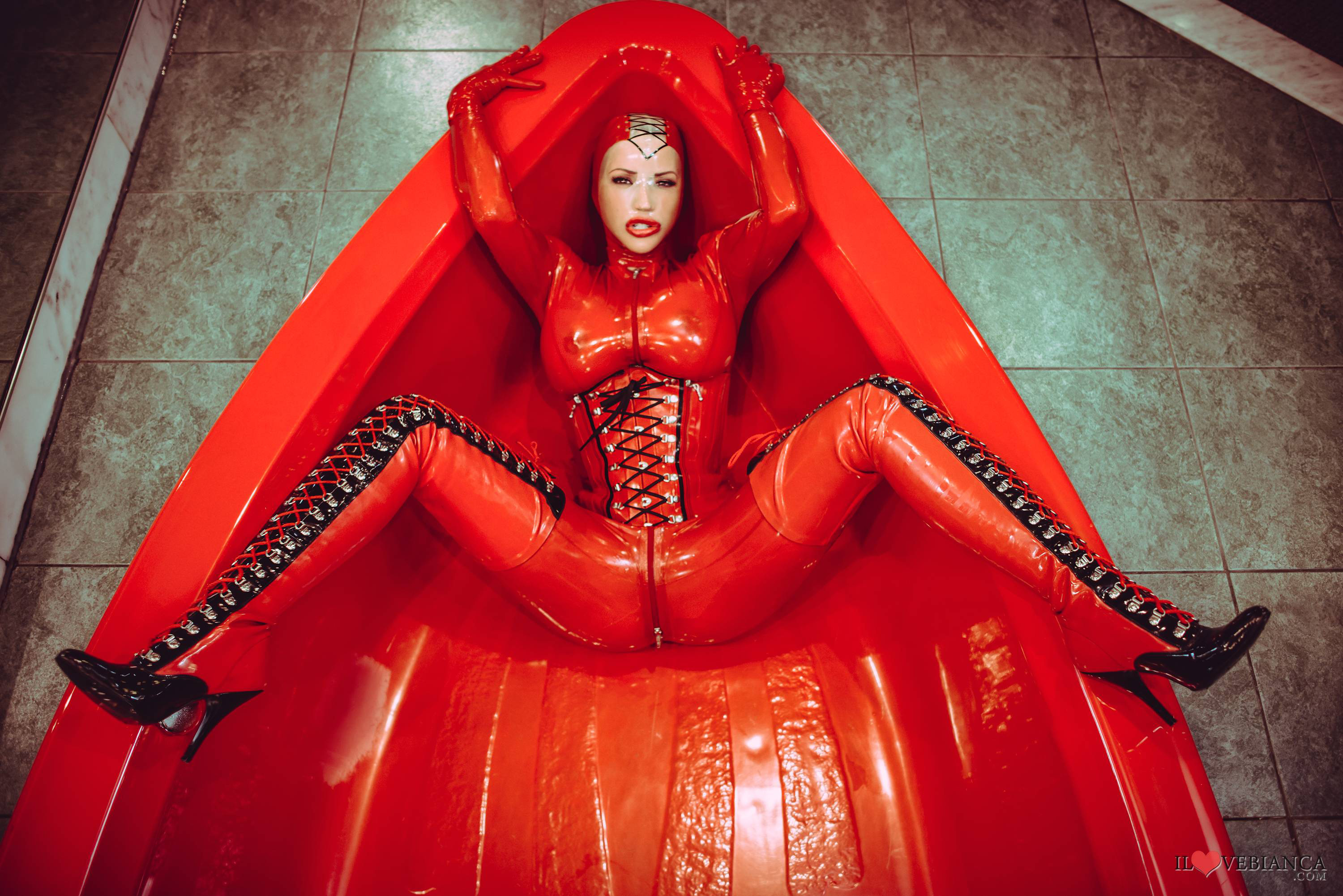 bianca_beauchamp breasts catsuit corset female large_breasts latex long_hair mask red_hair solo watermark