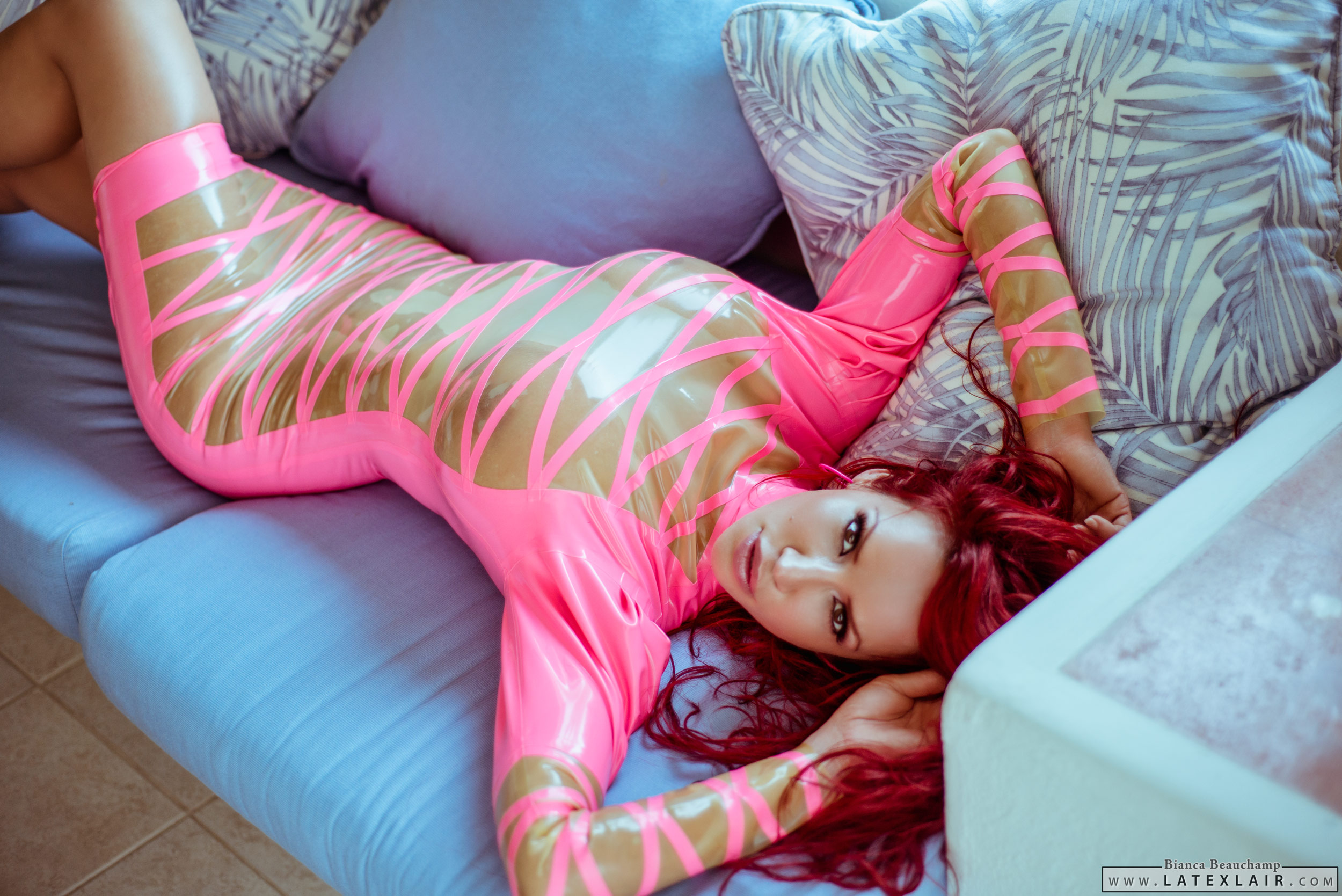 bed bianca_beauchamp breasts dress earrings female large_breasts latex long_hair red_hair see-through solo watermark