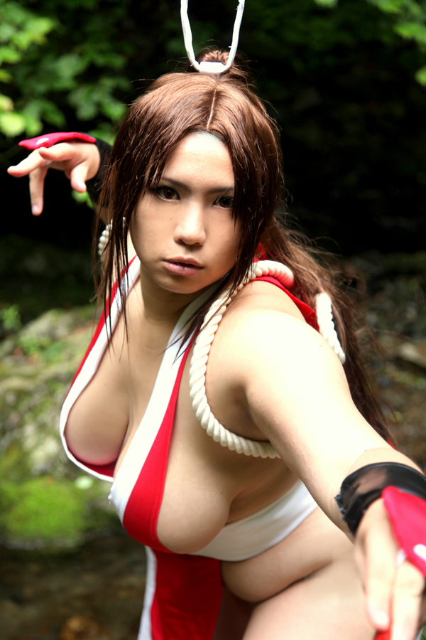 asian breasts brown_eyes brown_hair chouzuki_maryou cosplay fan fat_mons female female_only hair_ornament hanging_breasts king_of_fighters large_breasts leaning_forward long_hair mai_shiranui mai_shiranui_(cosplay) plump ponytail pose snk solo thick_thighs thighs tied_hair very_long_hair