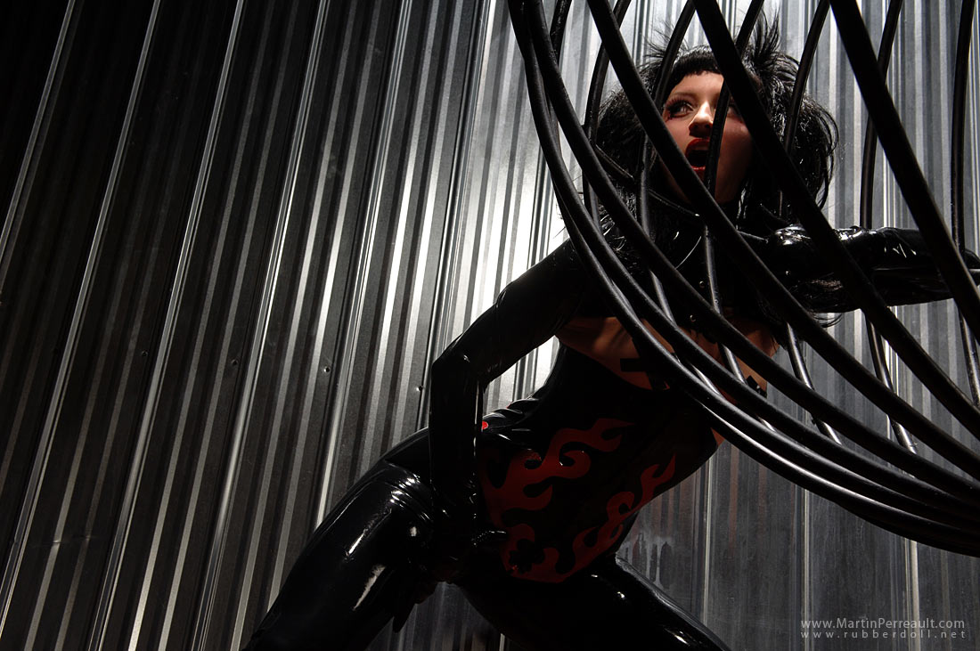 black_hair breasts cage female large_breasts latex long_hair rubberdoll solo watermark