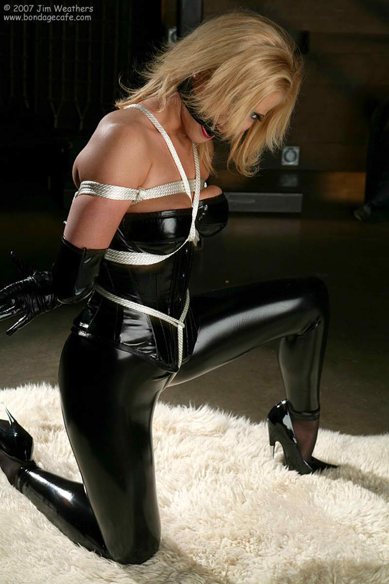 belt blonde_hair breasts corset elbow_gloves emily_addison female gloves high_heels large_breasts latex lipstick long_hair shoes solo watermark