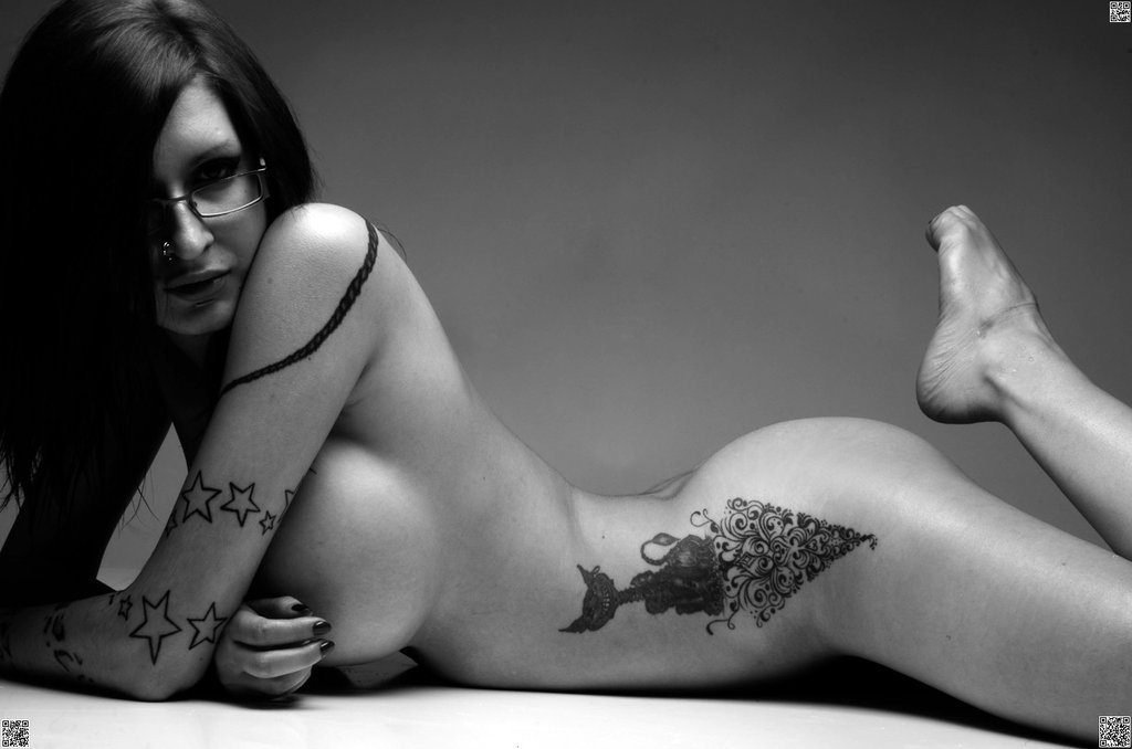 1girl breasts glasses greyscale human monochrome nose_piercing photo piercing qr_code solo star star_tattoo tattoo