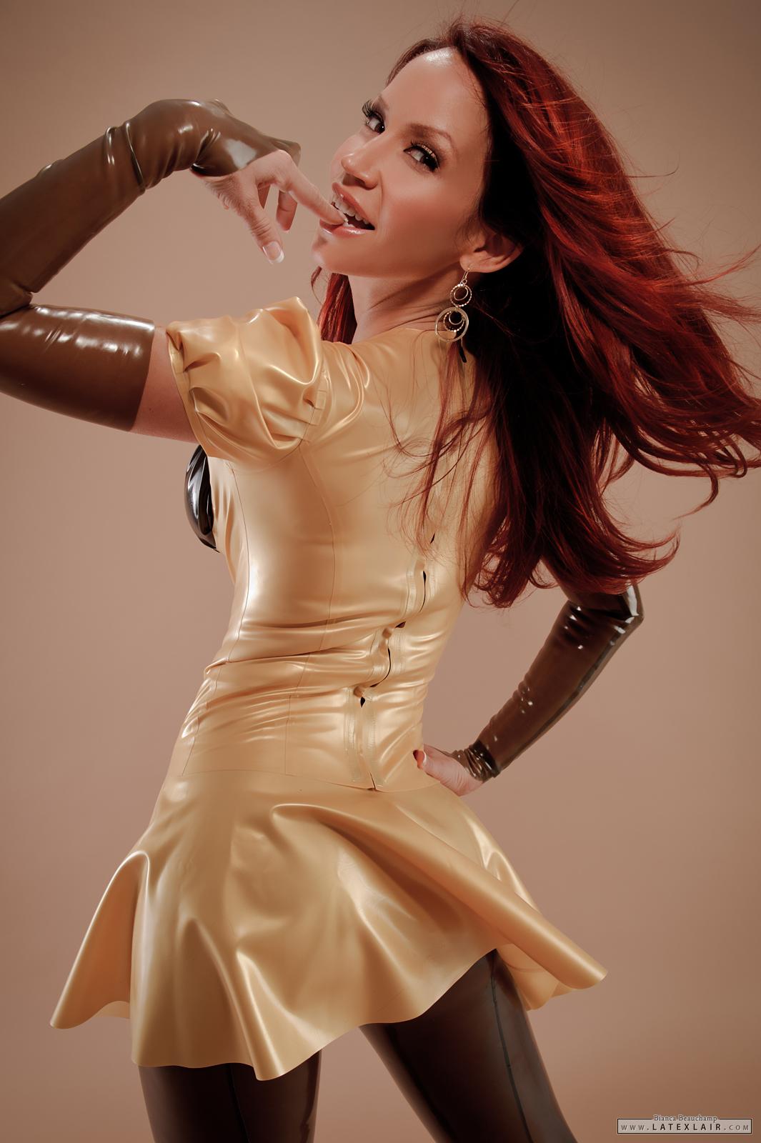 bianca_beauchamp breasts cleavage dress earrings female gloves large_breasts latex long_hair red_hair simple_background solo watermark