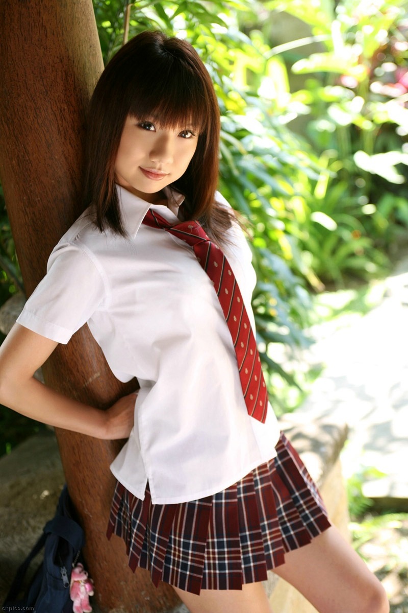against_wall asian brown_eyes brown_hair japanese outside school_uniform schoolgirl seifuku skirt slender smile solo tie