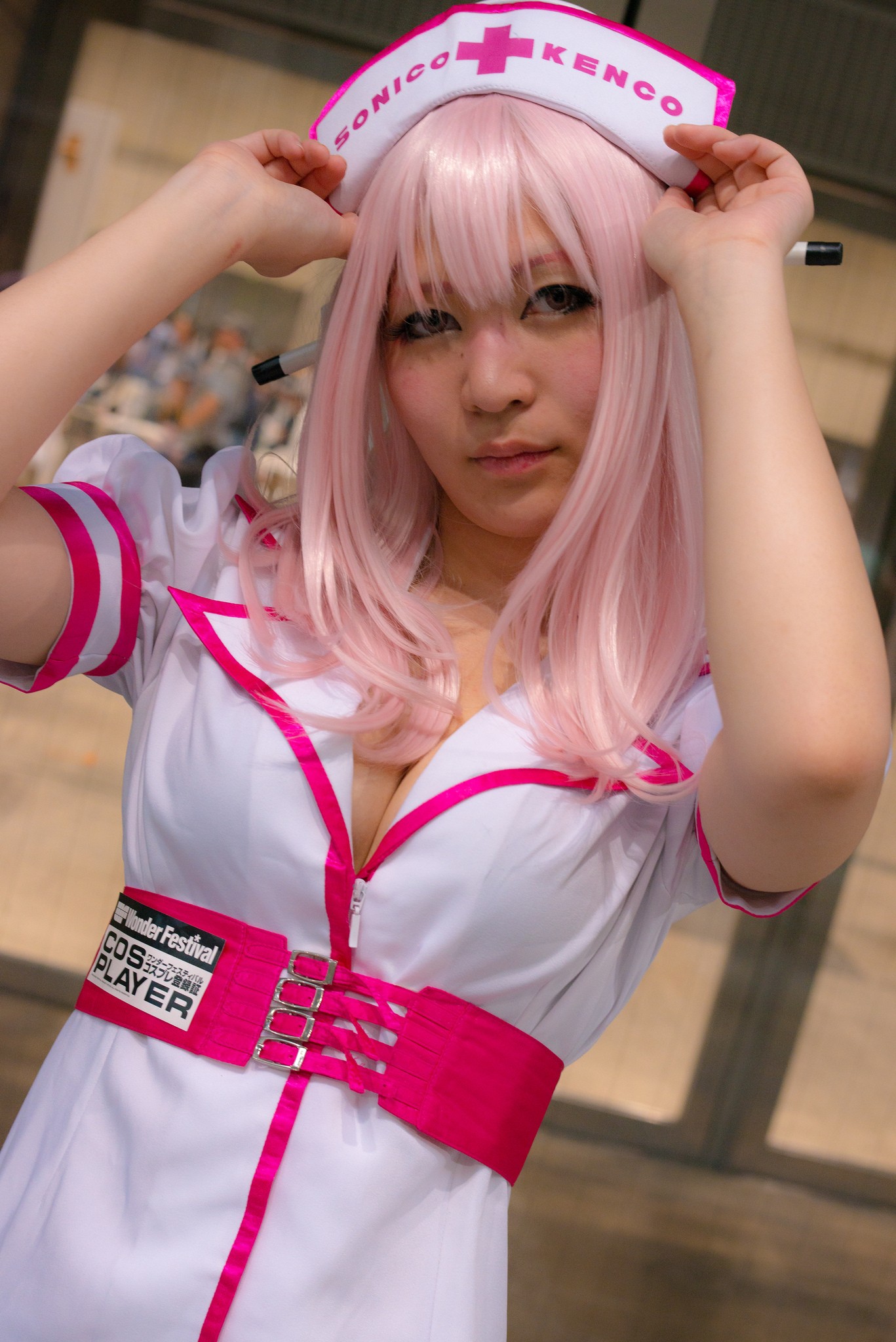 1girl asian breasts cleavage cosplay dress female headphones japanese long_hair nurse pink_hair solo super_sonico