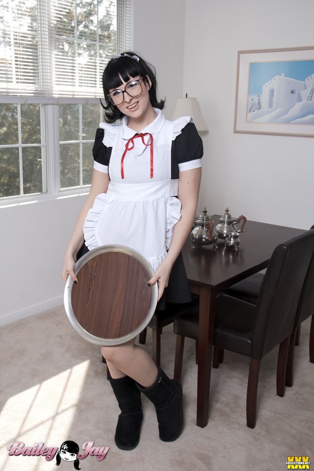 bailey_jay black_hair boots breasts clothed glasses large_breasts long_hair looking_at_viewer maid nail_polish non-nude ponytail porn_star shemale smile solo transgender watermark white