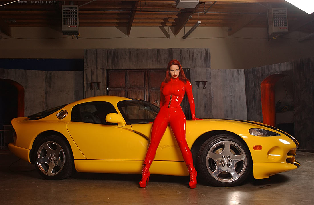 bianca_beauchamp breasts car catsuit female large_breasts long_hair red_hair solo watermark