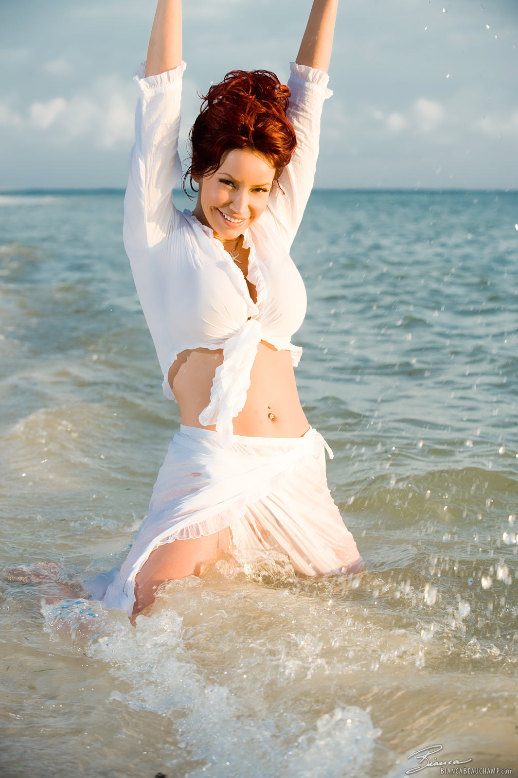 arms_up bianca_beauchamp breasts female large_breasts latex long_hair navel navel_piercing piercing red_hair smile solo water wet