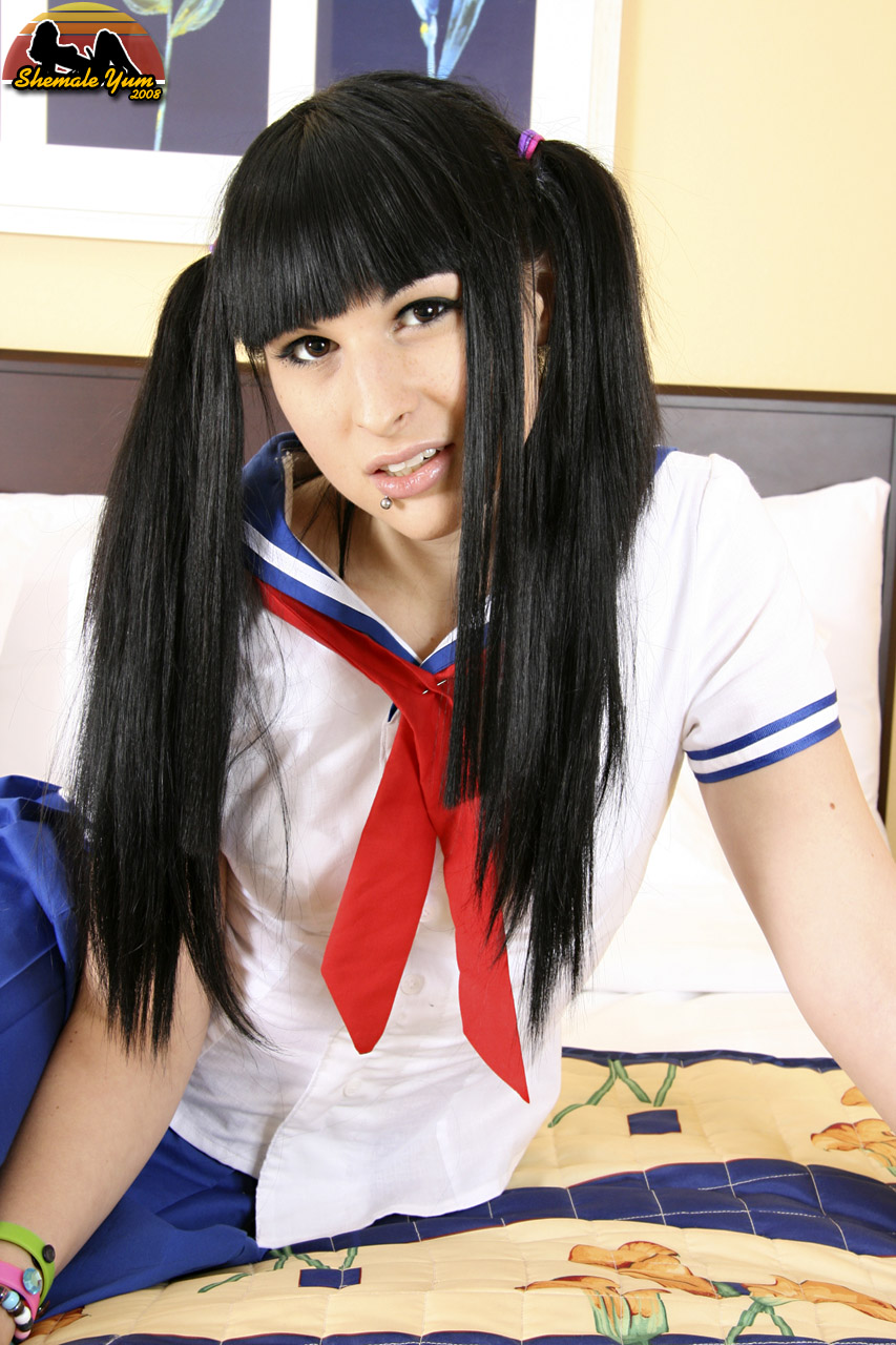 bailey_jay black_hair breasts clothed lip_piercing long_hair looking_at_viewer non-nude on_bed parted_lips piercing porn_star schoolgirl shemale shemaleyum solo transgender watermark white