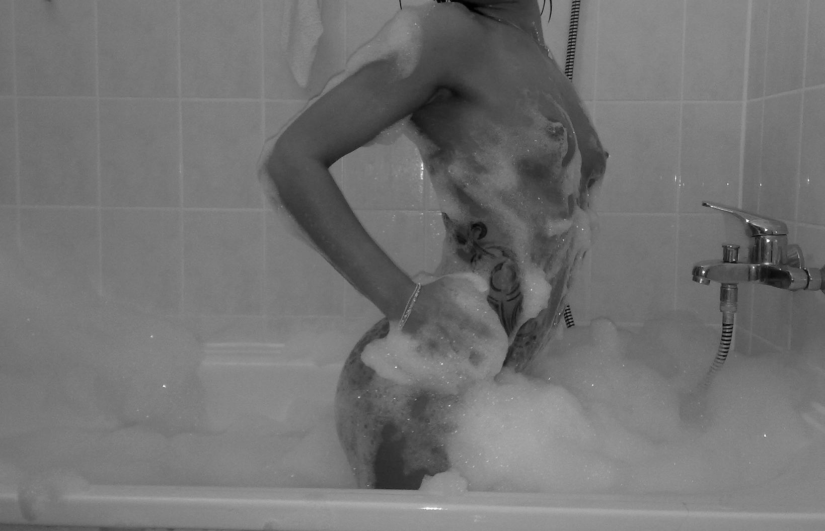 1_female 1_girl 1_human bath bathroom bathtub breasts female female_human female_only foam hair human human_only indoors kneeling monochrome mostly_nude nipples nude photo real real_person side_view small_breasts solo tattoo wet
