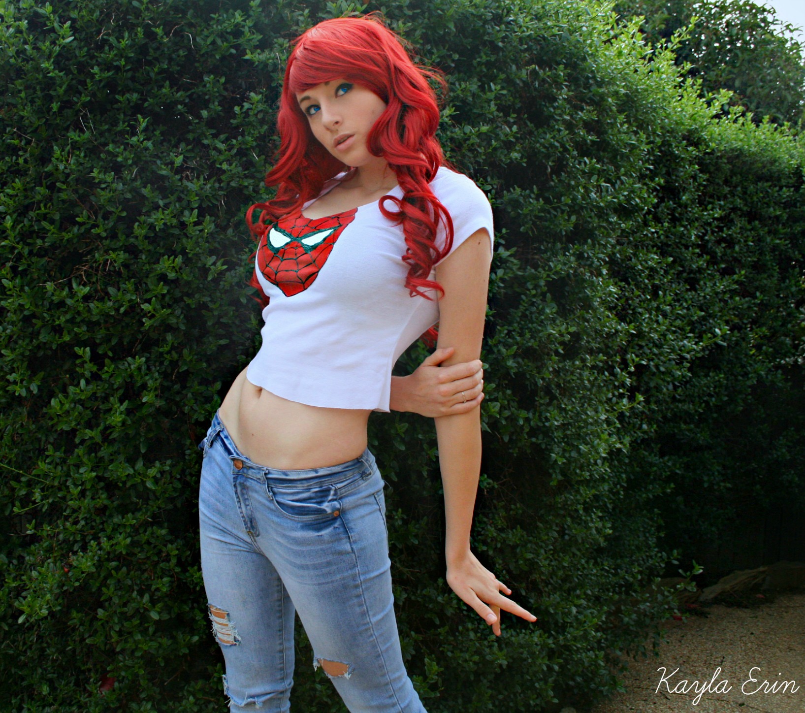 breasts cosplay female jeans kayla_erin large_breasts long_hair marvel mary_jane_watson midriff navel red_hair shirt solo
