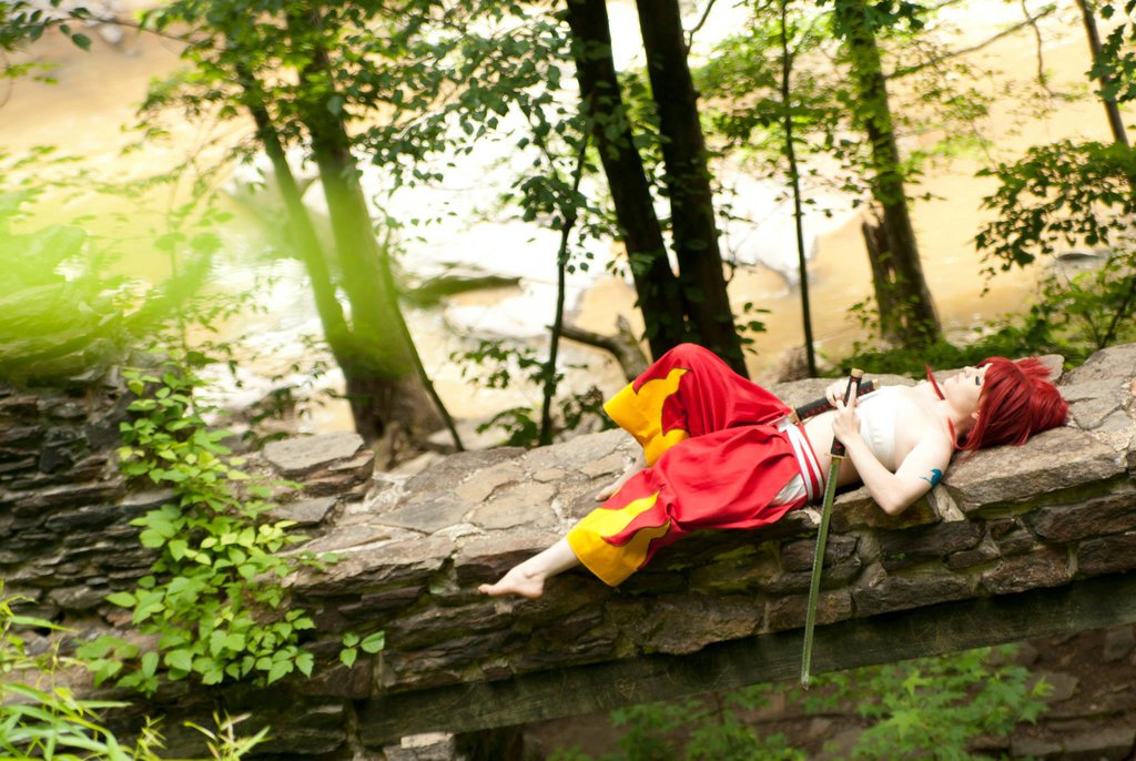 1girl breasts cosplay erza_scarlet fairy_tail female foxycosplay long_hair lying outside red_hair solo sword tagme