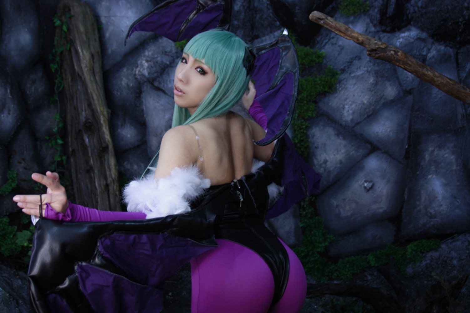 1girl asian ass backless bare_shoulders breasts capcom cleavage clothed cosplay darkstalkers female female_only from_behind green_hair large_breasts leotard long_hair looking_back morrigan_aensland non-nude nonsummerjack solo succubus thong thong_leotard wings