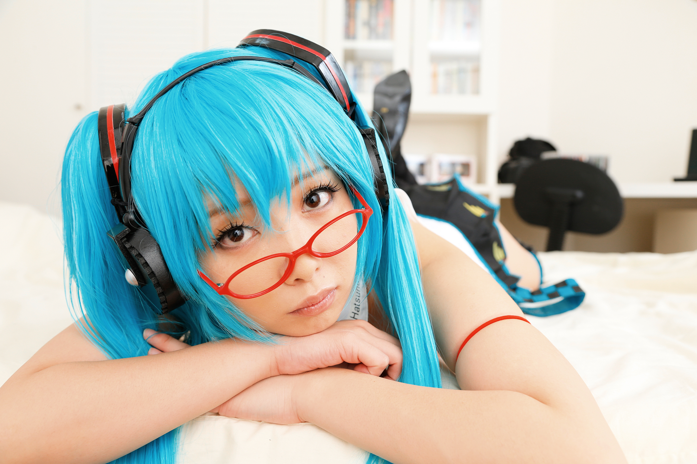 asian bed blue_hair breasts cosplay female glasses headphones high_heels long_hair necktie shoes skirt socks solo