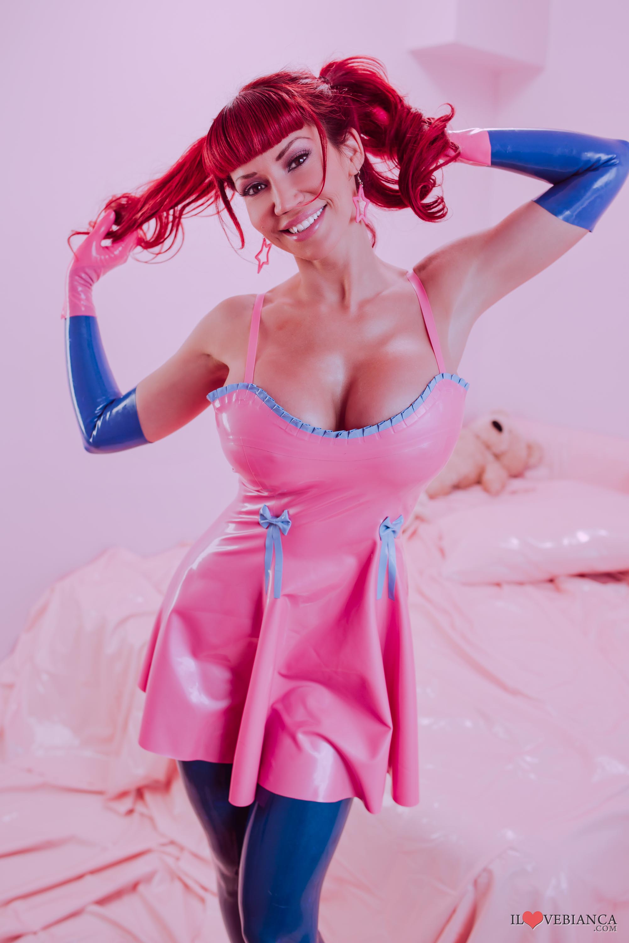 bianca_beauchamp breasts dress female high_heels large_breasts latex long_hair red_hair shoes simple_background solo thighhighs watermark