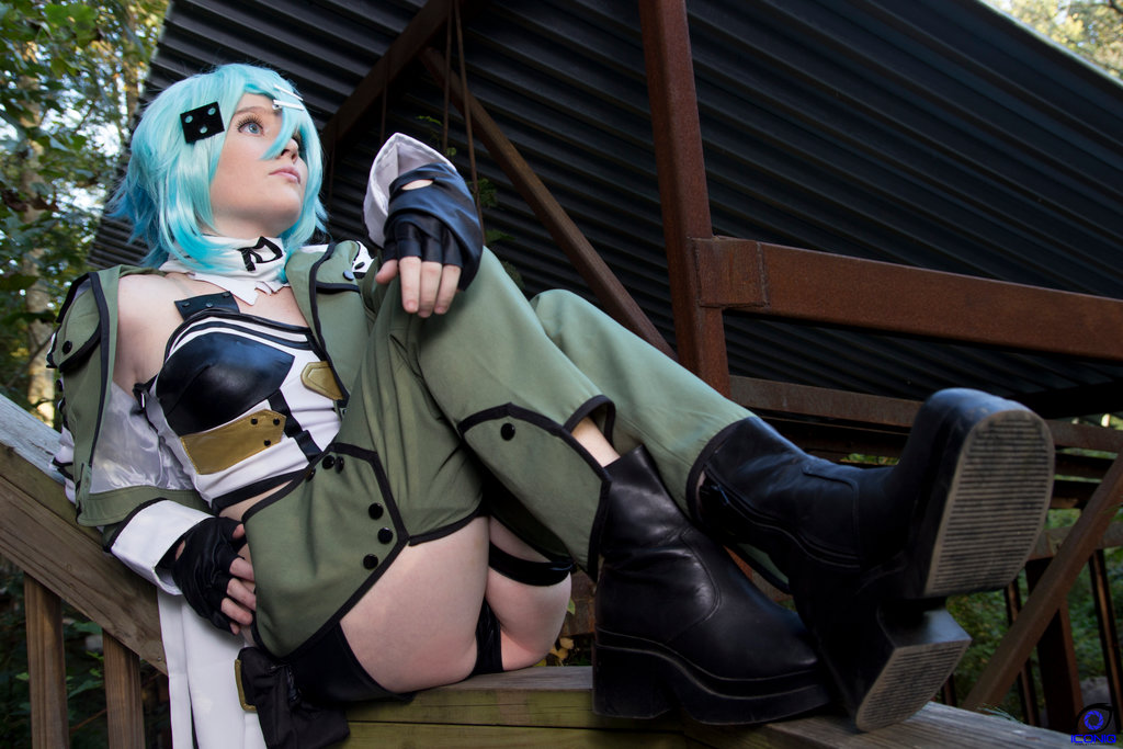 1girl boots breasts cosplay female foxycosplay from_below green_hair long_hair sinon sitting small_breasts solo sword_art_online tagme