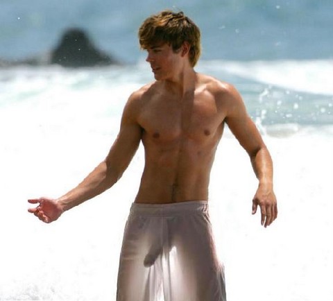 1boy abs beach human long_penis male male_only ocean penis photo see_through swimsuit water zac_efron