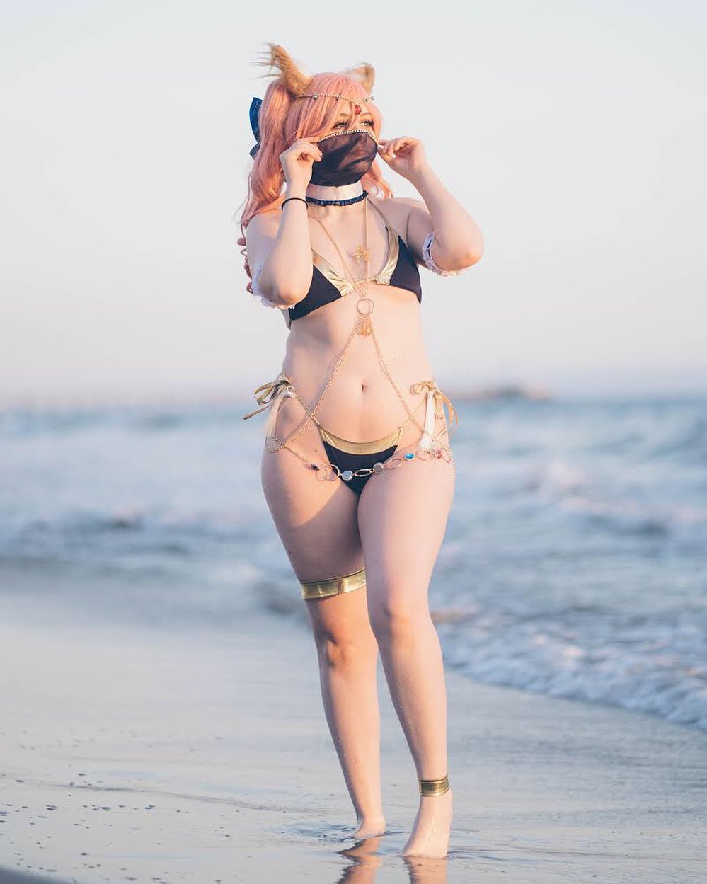 1girl anklet ass bare_shoulders barefoot bikini cosplay fate/grand_order female female_only fox_ears jewelry legs mask navel necklace nyautumn outside pink_hair side-tie_bikini solo swimsuit tamamo_no mae water