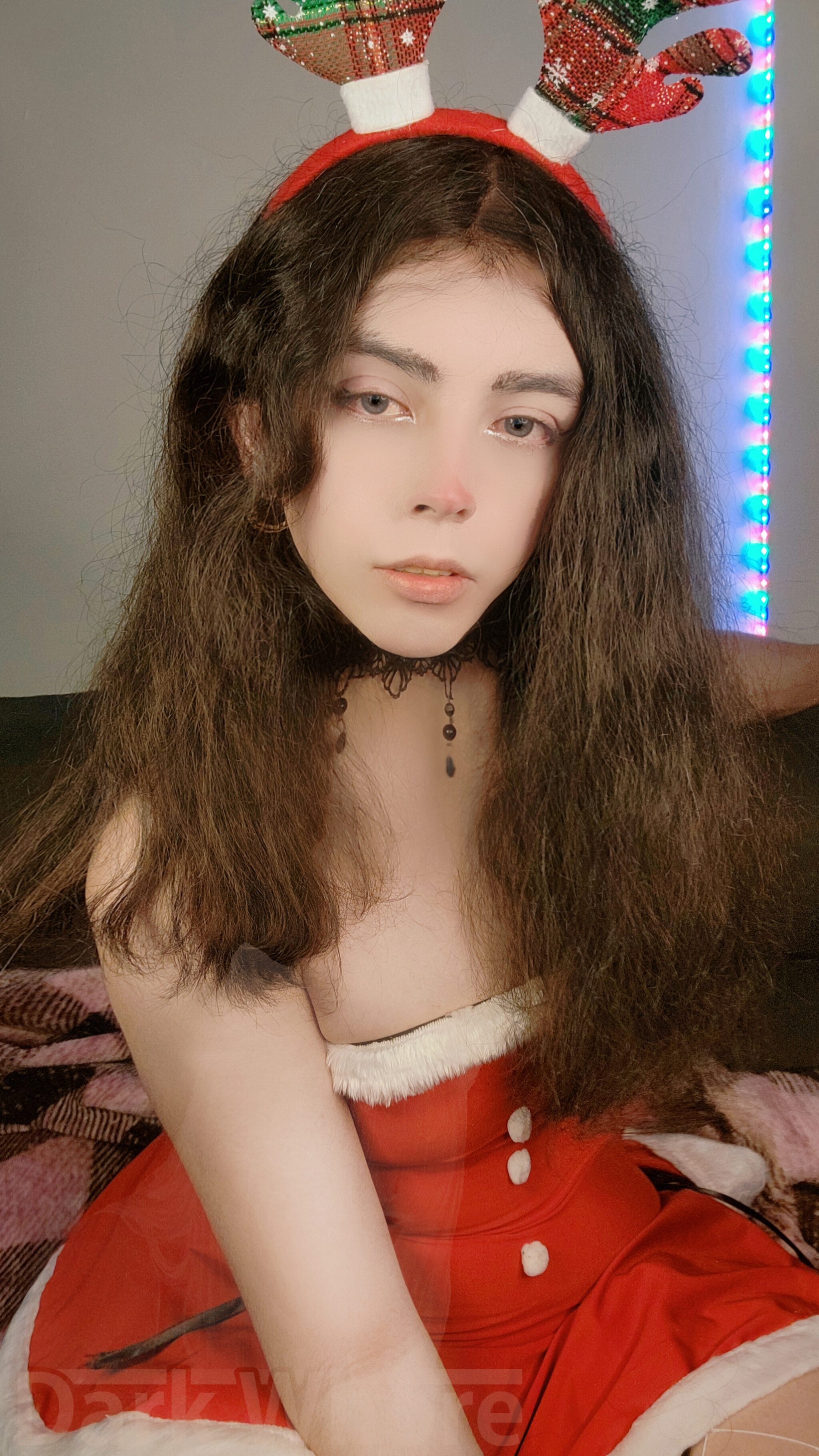 1boy 1girl antlers bed bedroom brown_hair brunette christmas christmas_outfit darkwaifutrap femboy feminine lipstick long_hair looking_at viewer makeup male male_focus male_only male_solo on_bed selfie sitting solo thick thick_thighs thighs trap