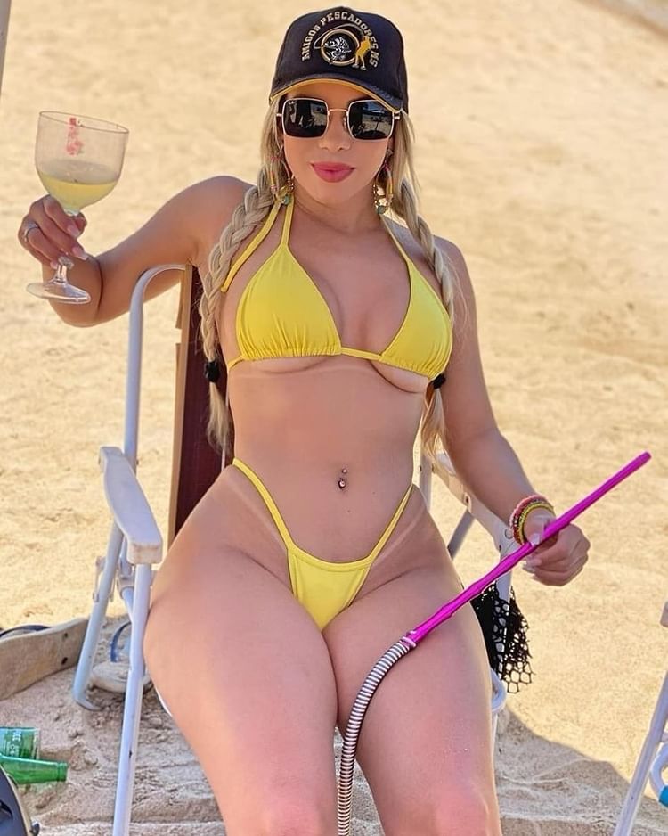 1girl beach bikini braid braided_twintails braids breasts cap eyewear female glass hat large_breasts name_request navel navel_piercing outdoors sand sitting source_request sunglasses thick_thighs thighs twin_braids twintalis wide_hips wine_glass yellow_bikini