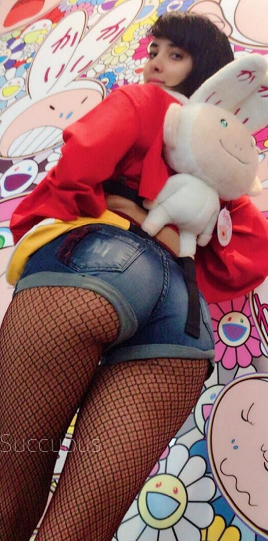 1girl ass backpack black_hair booty_shorts female female_focus female_only female_solo fishnets goth leggings lipstick long_hair looking_at viewer looking_back makeup petite plushie presenting_ass shorts solo standing susu_jpg sweater swimsuit_succubus text watermark