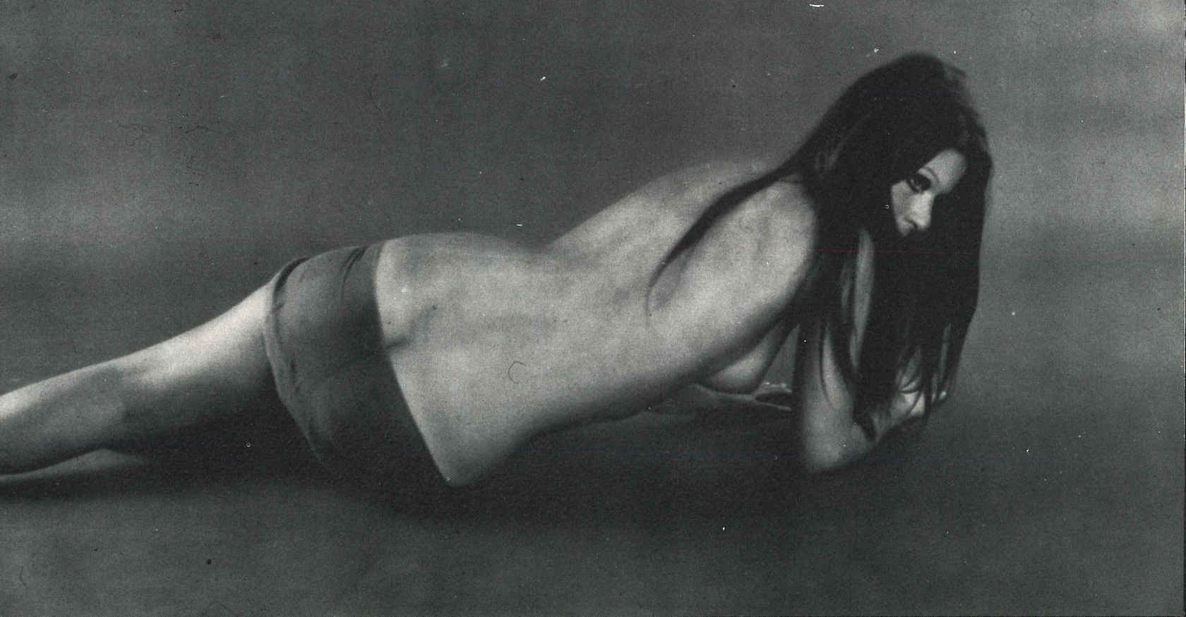 1960s absurdres ass emotionless emotionless_female erect_nipple expressionless greyscale heavenly_ass highres large_breast long_hair lying_down massive_ass miniskirt model modeling original patrizia_adiutori photoshoot posing short_skirt sideboob skirt swim_skirt topless_female
