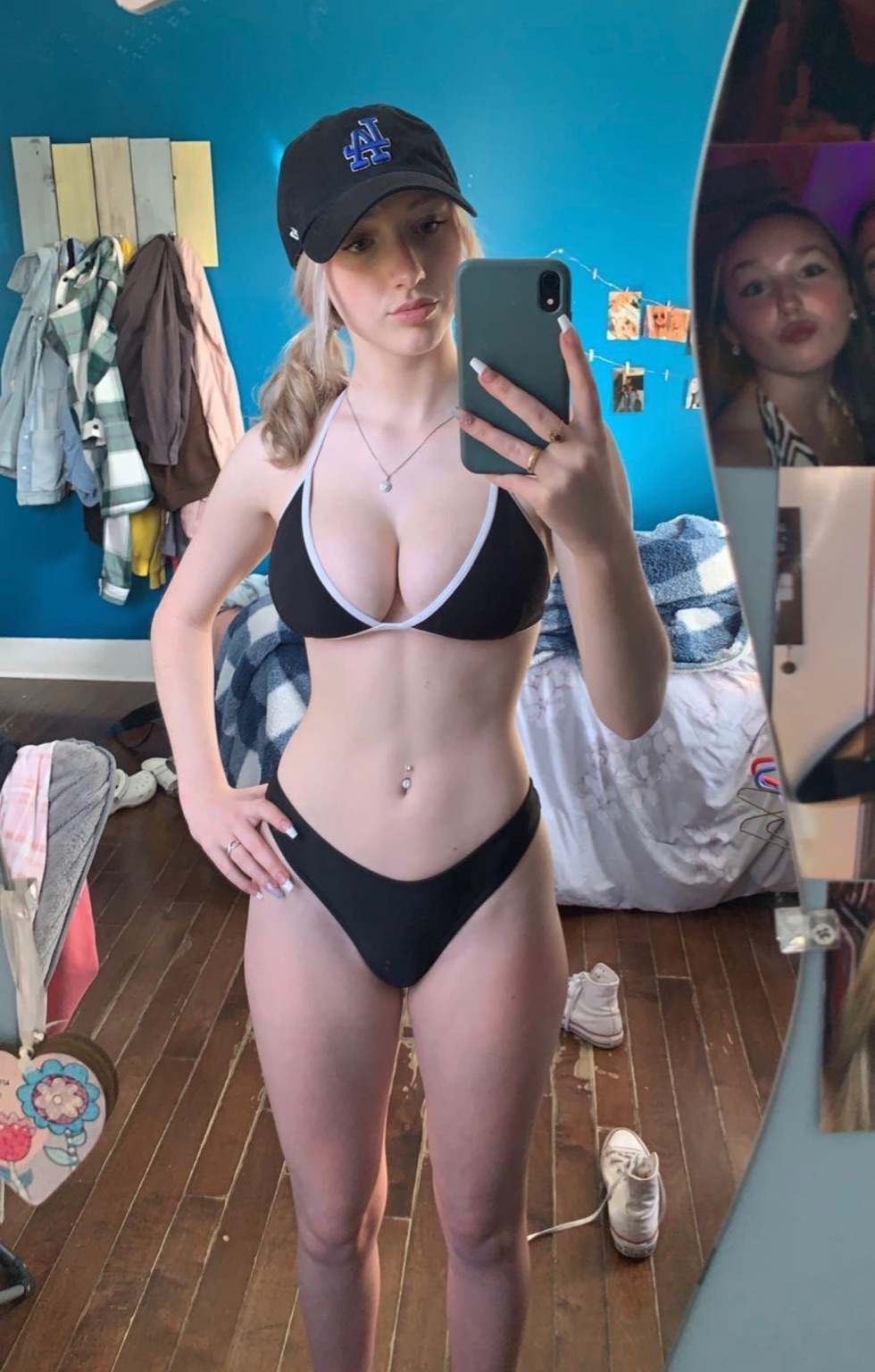 1girl bikini blonde_hair breasts cleavage indoors large_breasts legs mirror navel navel_piercing selfie