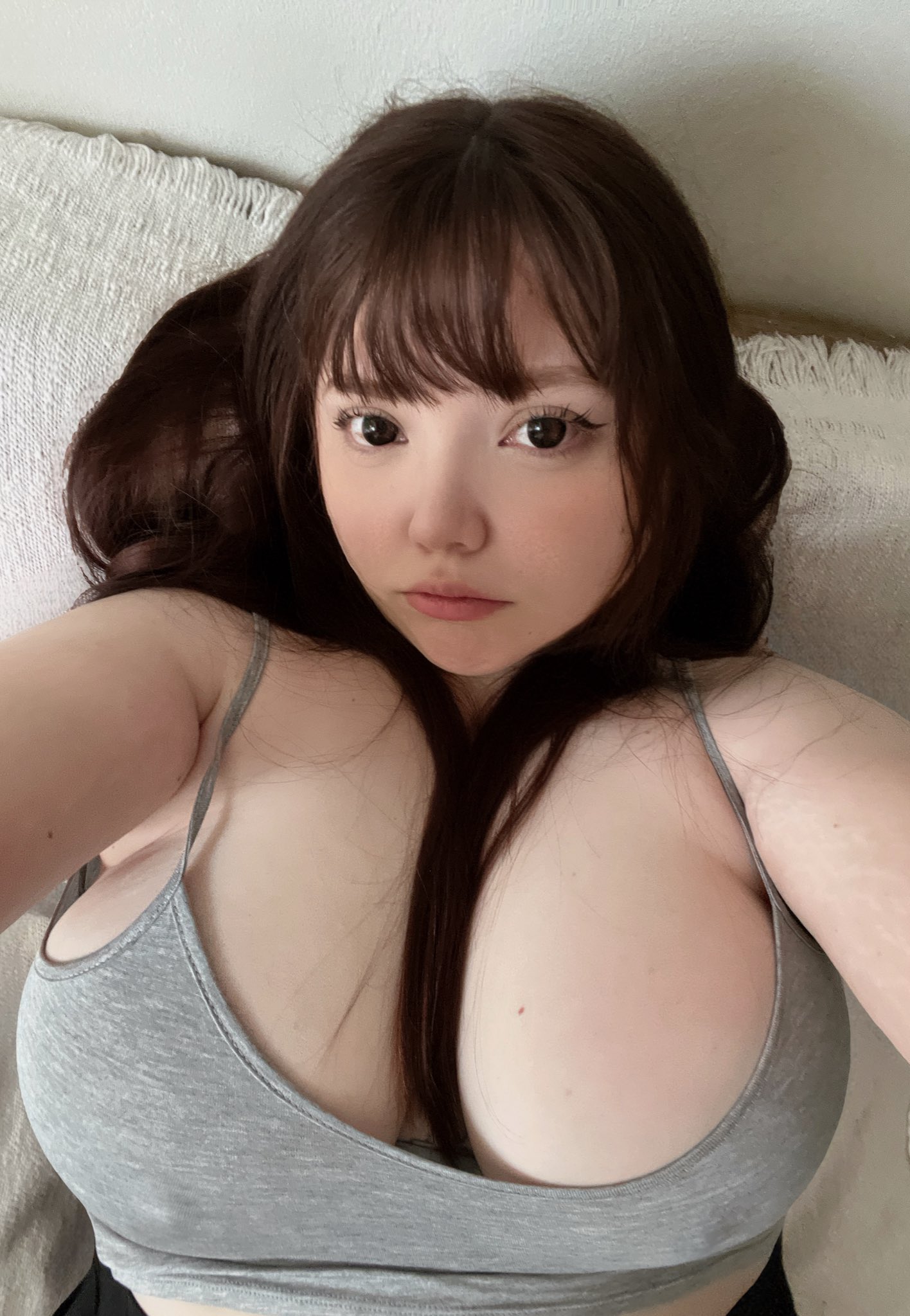 1girl bed bedroom big_breasts breasts brown_hair brunette ceoofgothicc cleavage female female_focus female_only female_solo lipstick long_hair looking_at viewer lying_on back makeup on_bed selfie solo