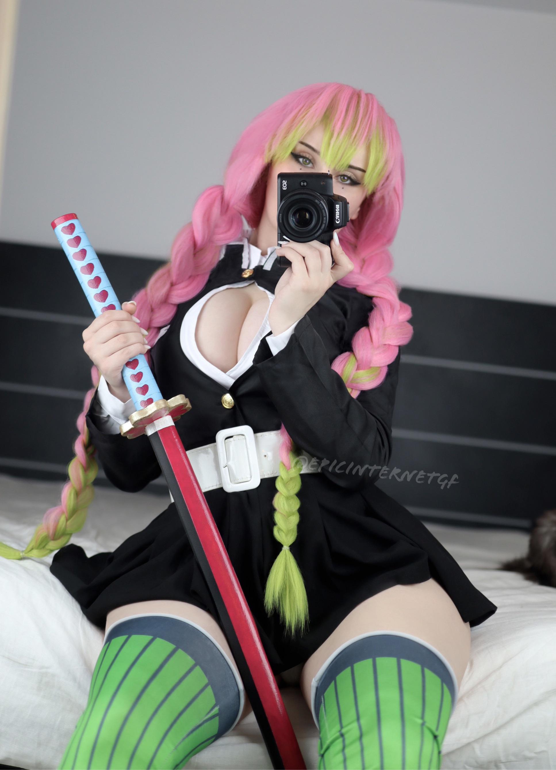 1girl artist_name cleavage cosplay cosplay_photo demon_slayer epicinternetgf female_focus green_hair green_thigh highs holding_sword japanese_clothes kanroji_mitsuri kanroji_mitsuri (cosplay) kimetsu_no yaiba large_breasts long_hair mitsuri_kanroji mole_under eye multicolored_hair pink_hair solo thighhighs twin_braids