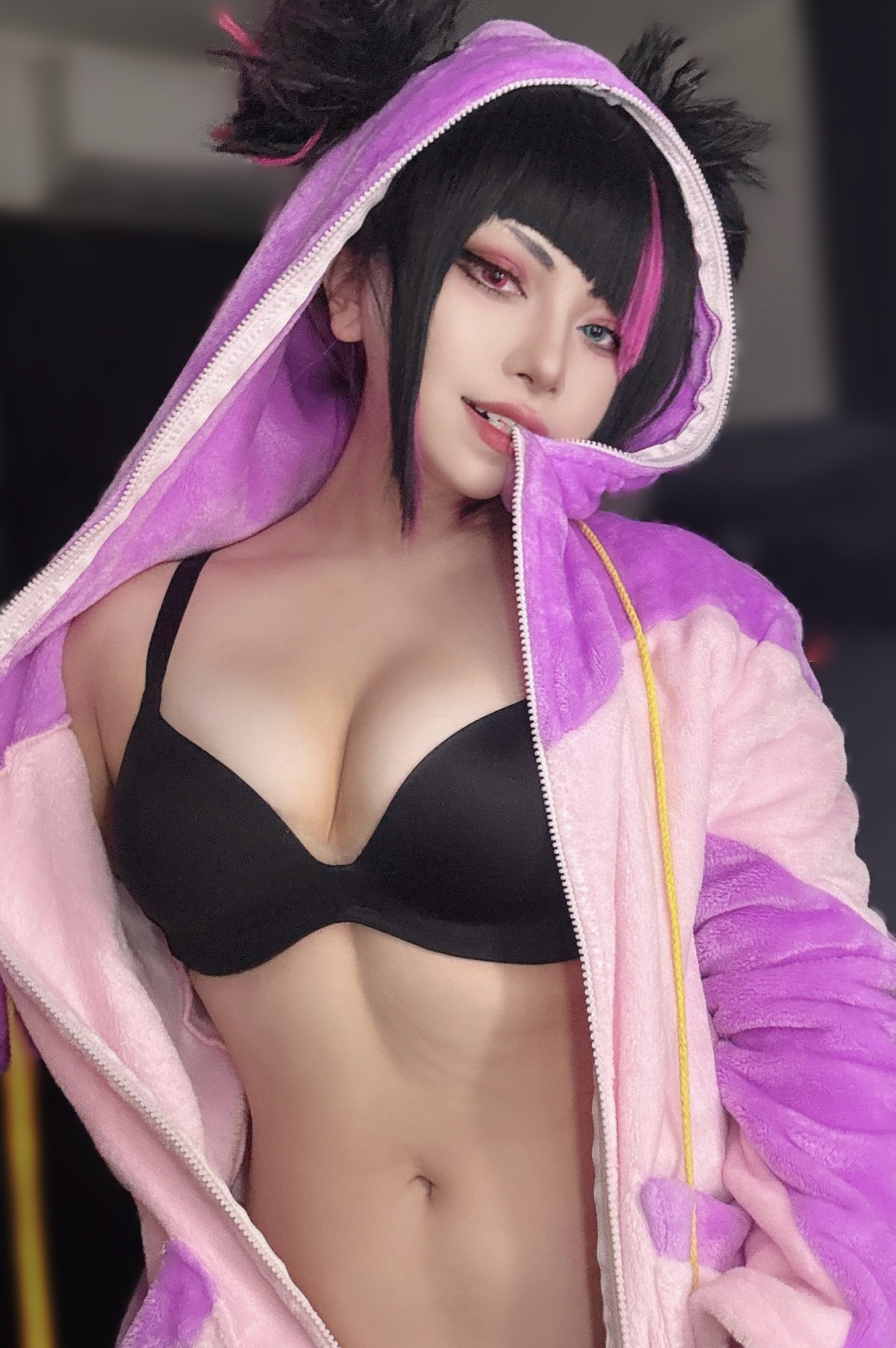 1girl big_breasts black_bra black_hair blue_eyes bra breasts busty capcom cleavage clothed clothing cosplay female female_solo heterochromia hoodie indoors juri_han large_breasts light-skinned_female light_skin looking_at viewer mouth_hold multicolored_eyes multicolored_hair navel onesie open_mouth purple_eyes purple_hair solo solo_female street_fighter teeth twitter two_tone hair unzipped watara1
