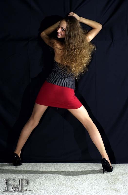 arms_up ass ass_focus bare_shoulders brown_eyes brown_hair collarbone eyewitness_production grin high_heels long_hair looking_back lowres miniskirt model modeling pantyhose red_miniskirt red_skirt short_skirt skirt smiling smug spread_legs suzanne_peter text tight_skirt unbothered watermark