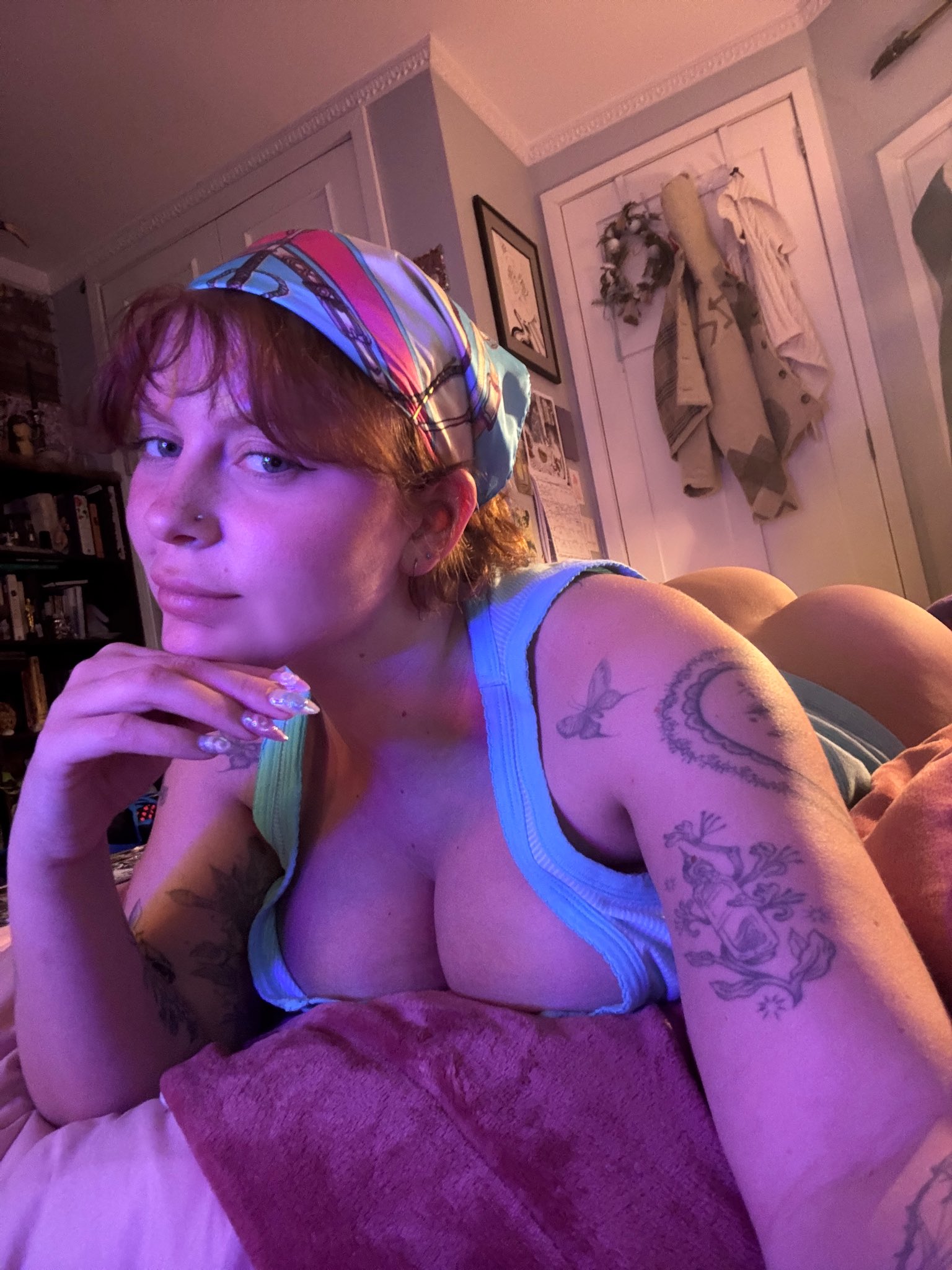 1girl ass bandana big_ass bottomless brown_hair female freckles long_fingernails misshortcake nose_piercing on_stomach pawg smile