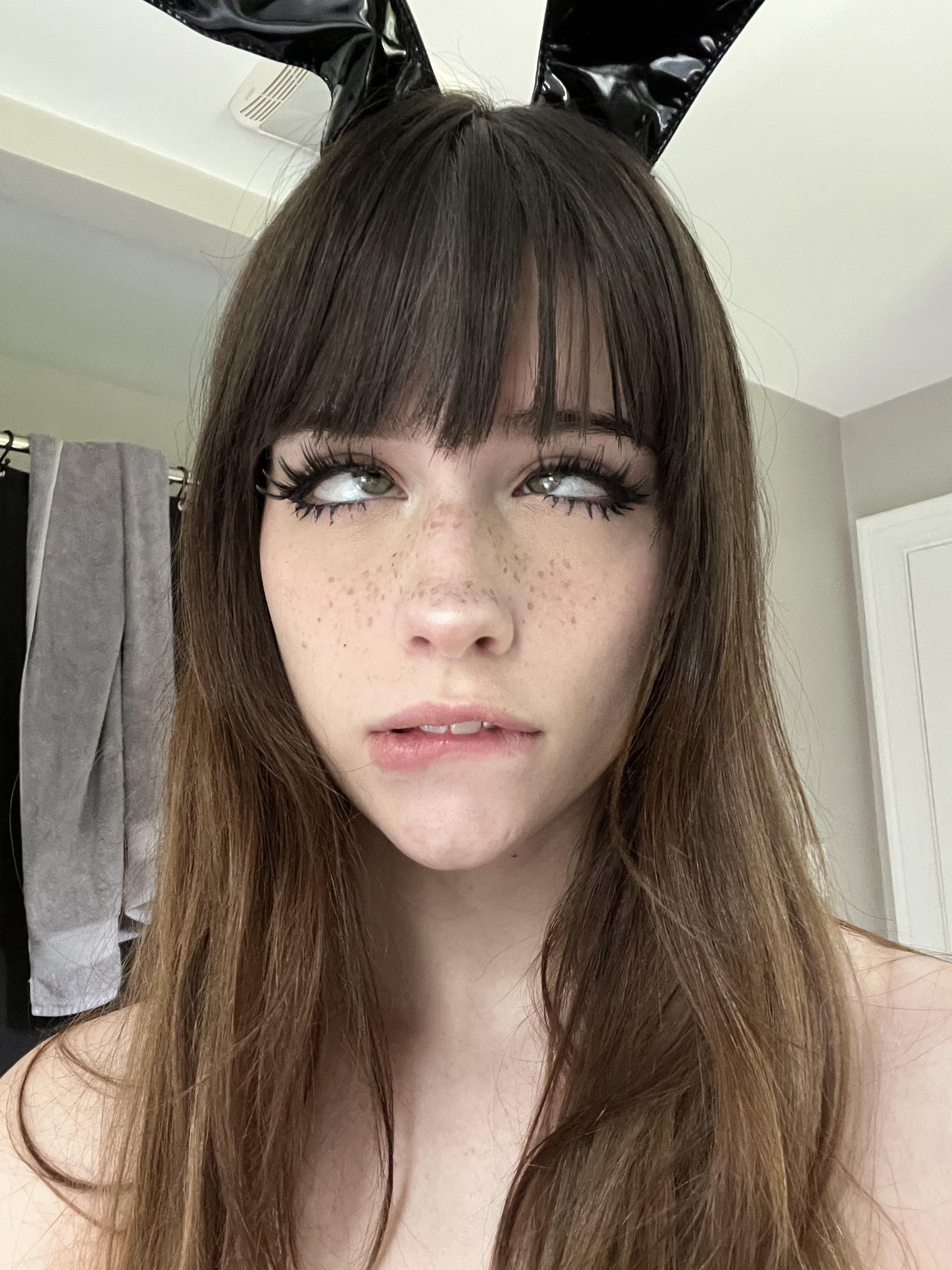 1girl ahegao bangs biting_lip brown_hair bunny_ears bunny_girl crossed_eyes female_only freckles long_hair solo soogsx