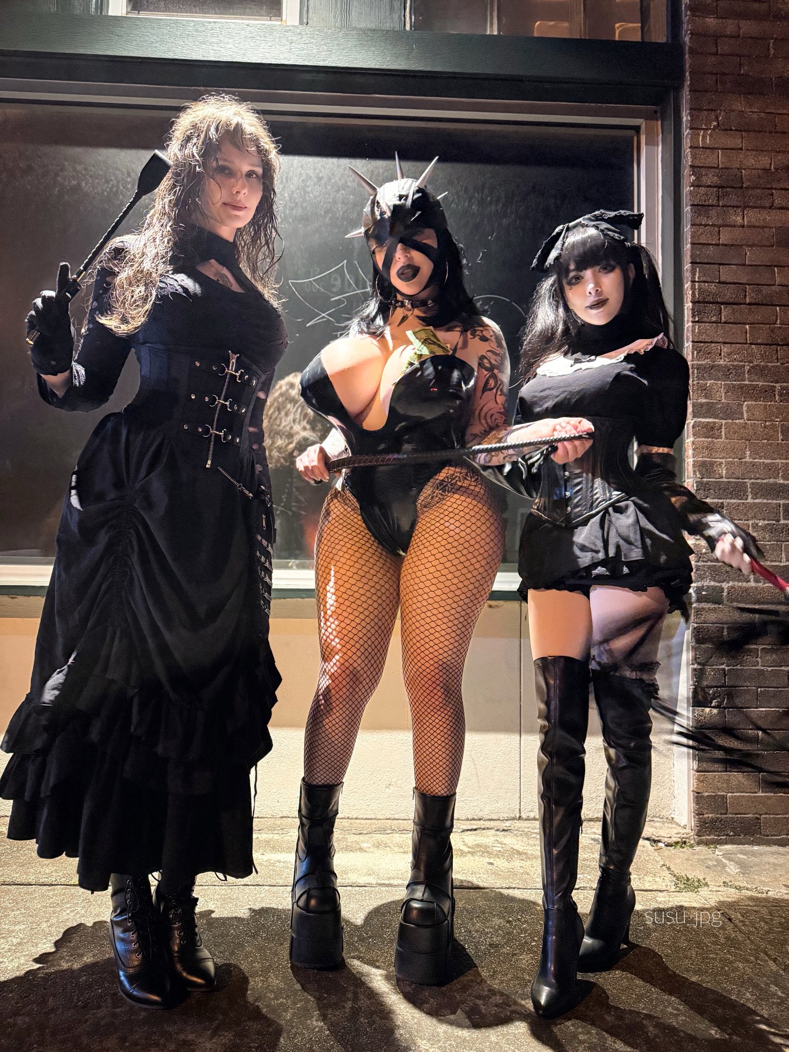 3girls arm_tattoo black_corset black_dress black_fishnet pantyhose black_fishnets black_gloves black_hair black_platform heels black_thigh boots boots brick_wall character_request cleavage corset dominatrix dreess fishnet_pantyhose fishnets full_body gloves goth goth_girl helmet huge_breasts large_breasts latex leotard lipstick mask model_request mommy platform_heels riding_crop skirt susu_jpg swimsuit_succubus tall tattoo thigh_boots whip