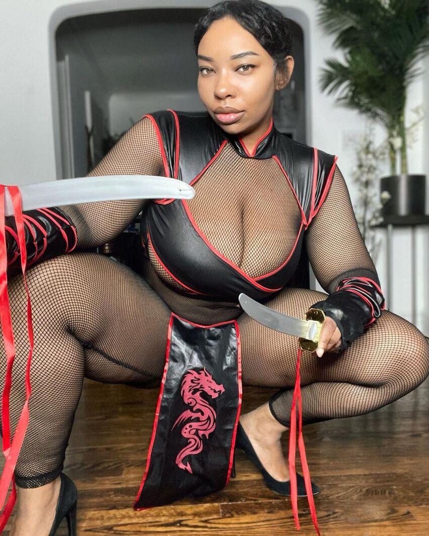 1girl black_hair breasts clothed clothed_female cosplay ebony female female_focus female_only female_solo huge_breasts long_hair looking_at_viewer mortal_kombat rachel_storms solo solo_female solo_focus weapon