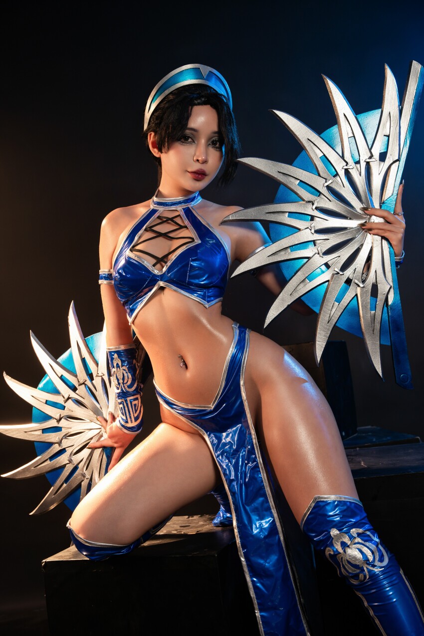 1girl asian asian_female belly belly_button belly_button_piercing black_hair cosplay dark_hair dark_haired_female highres hips indoors kitana legs mortal_kombat navel navel_piercing oil oiled pelvic_curtain photo photoshoot revealing_clothes shiny shiny_body shiny_skin simple_background solo solo_female solo_focus thighs umeko_j