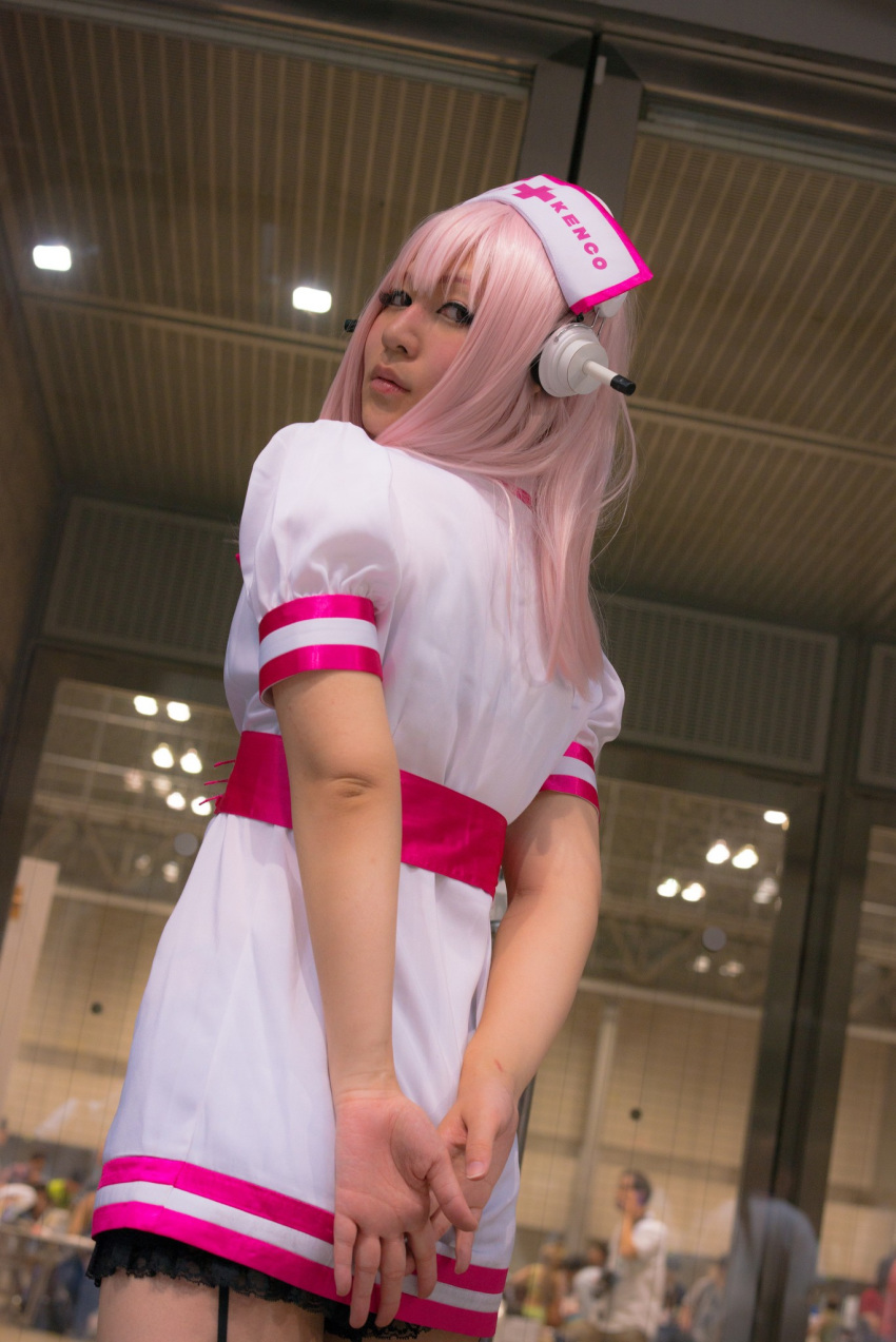 1girl asian breasts cosplay dress female headphones japanese long_hair nurse pink_hair solo super_sonico