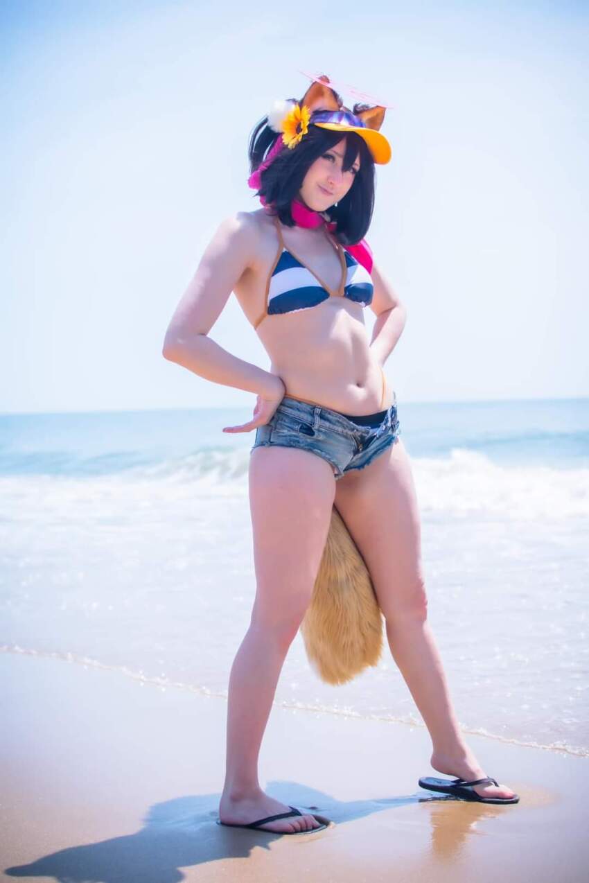 1girl beach bikini bikini_bottom bikini_top blue_archive cosplay cosplayer denim_shorts flip_flops izuna_(blue_archive) mangoloo sand sandals short_shorts striped_bikini tail water white_female