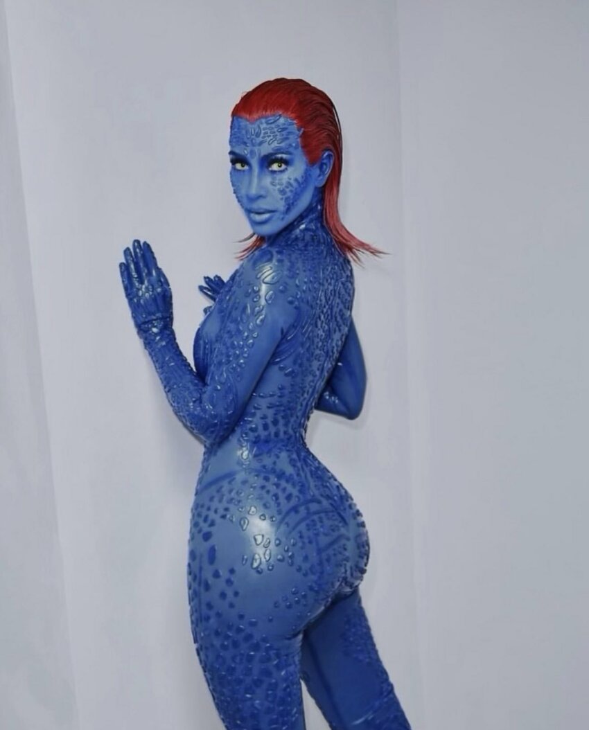 1girl against_wall ass big_ass blue_skin body_paint celebrity cosplay costume curvy female female_only halloween kim_kardashian looking_at_viewer marvel marvel_comics mystique nude nude_female red_hair solo solo_female x-men